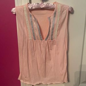 Sleeveless light pink top with embroidered flowers